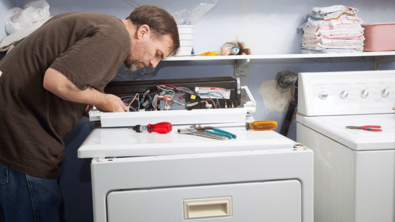 ApplianceCheck Technician looking into a dryer